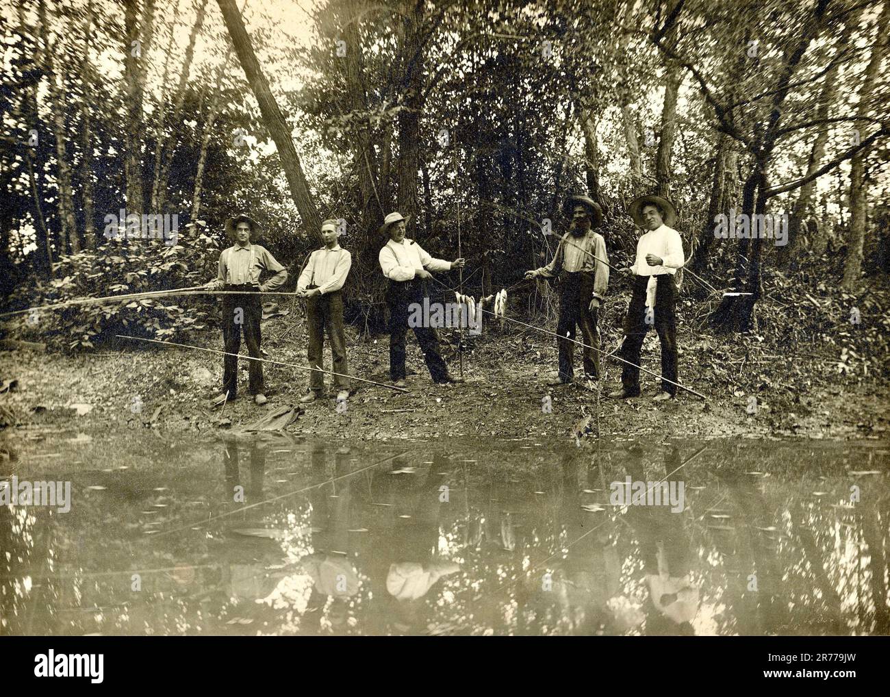 Fishing early 1900s, Vintage Fly Fishing, Old Fashioned Poles Stock Photo