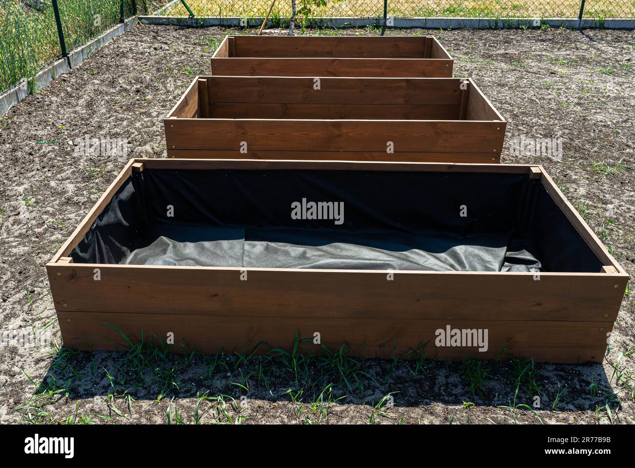 Ready wooden boxes for vegetables lined with agrotextile from the