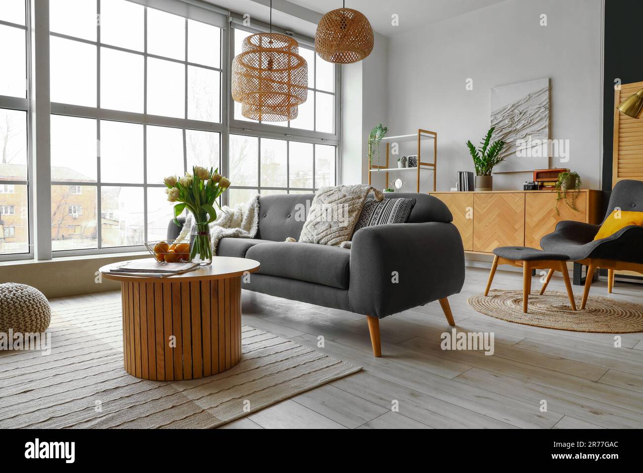 Interior of stylish living room with cozy sofa and coffee table near ...