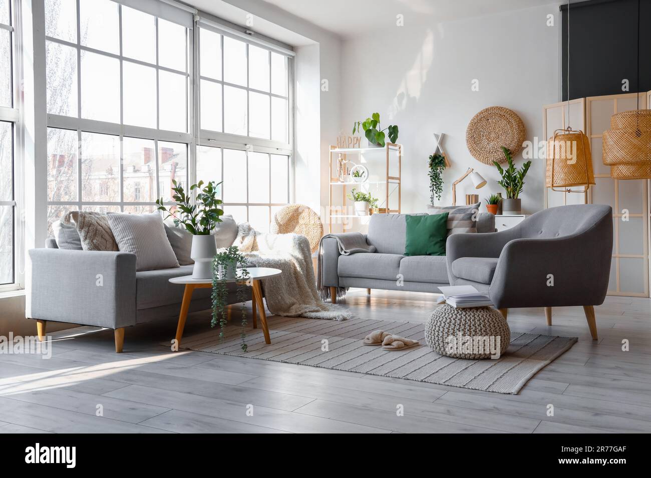 Interior of bright living room with cozy sofas and armchair near big ...
