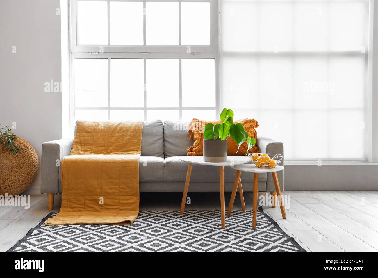 Interior of bright living room with cozy sofa and coffee table near big ...