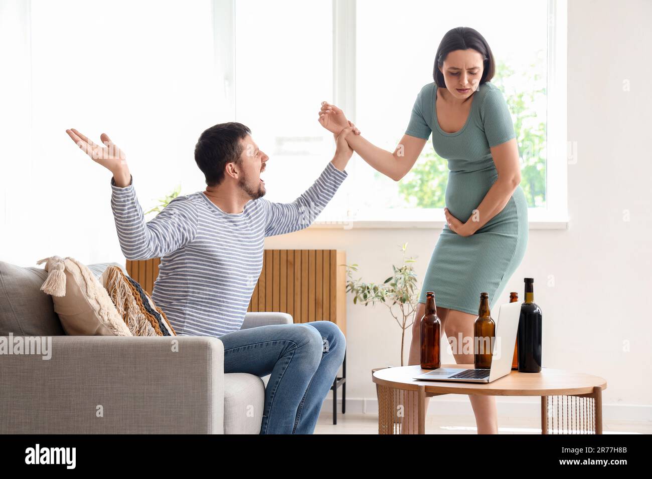 Drunk husband fighting with his pregnant wife at home. Domestic