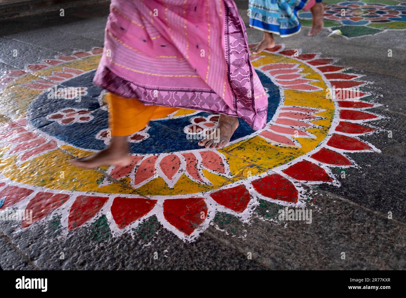 Worshiper crosses a mandala on stone floor, Ekambaranatha Temple