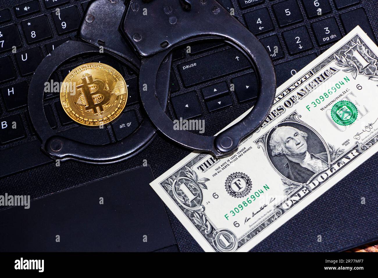 Police handcuffs and bitcoins. The concept of problems with the law in