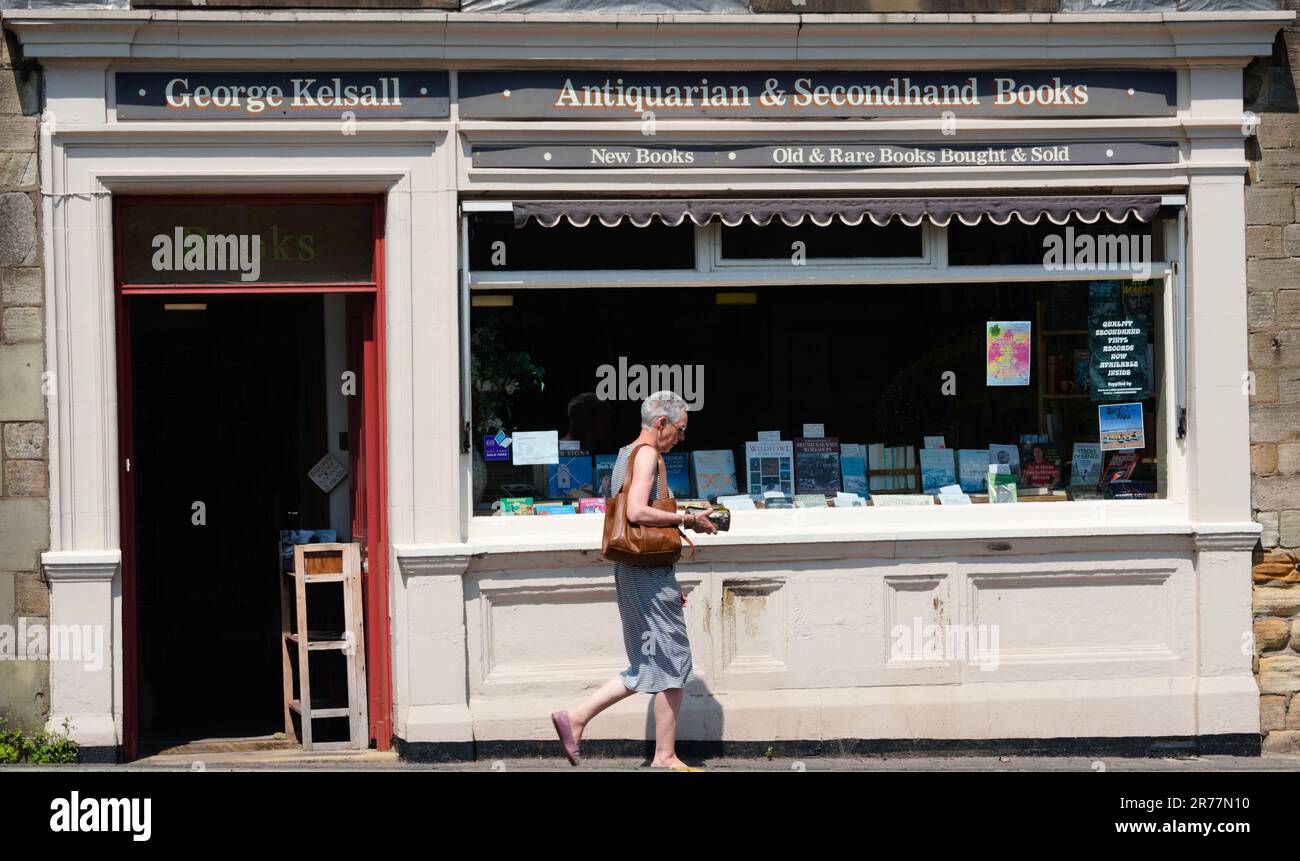 A person walks past exterior of George Kelsall Bookshop booksellers in  Littleborough, Greater Manchester, UK. Stock Photo