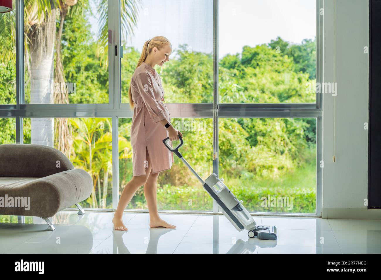 Young pregnant woman enjoys cleaning her house. Easy cleaning with a