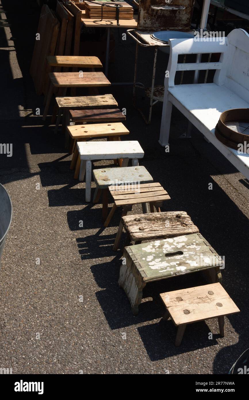 Collection of rustic foot stools in size order Stock Photo Alamy