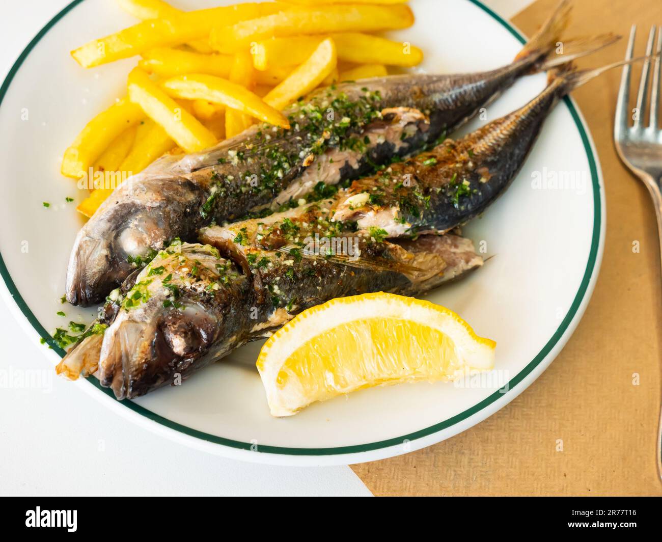 Grilled mackerel fish with french fries and lemon Stock Photo Alamy