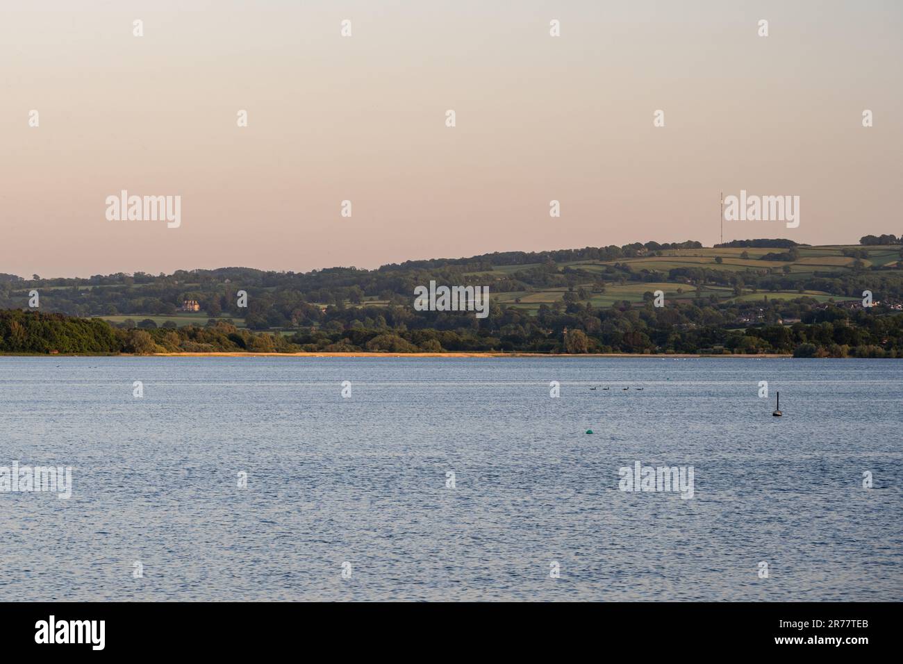 Evening sun shines on Bristol Water's Chew Valley Lake reservoir and the Mendip Hills in north Somerset. Stock Photo