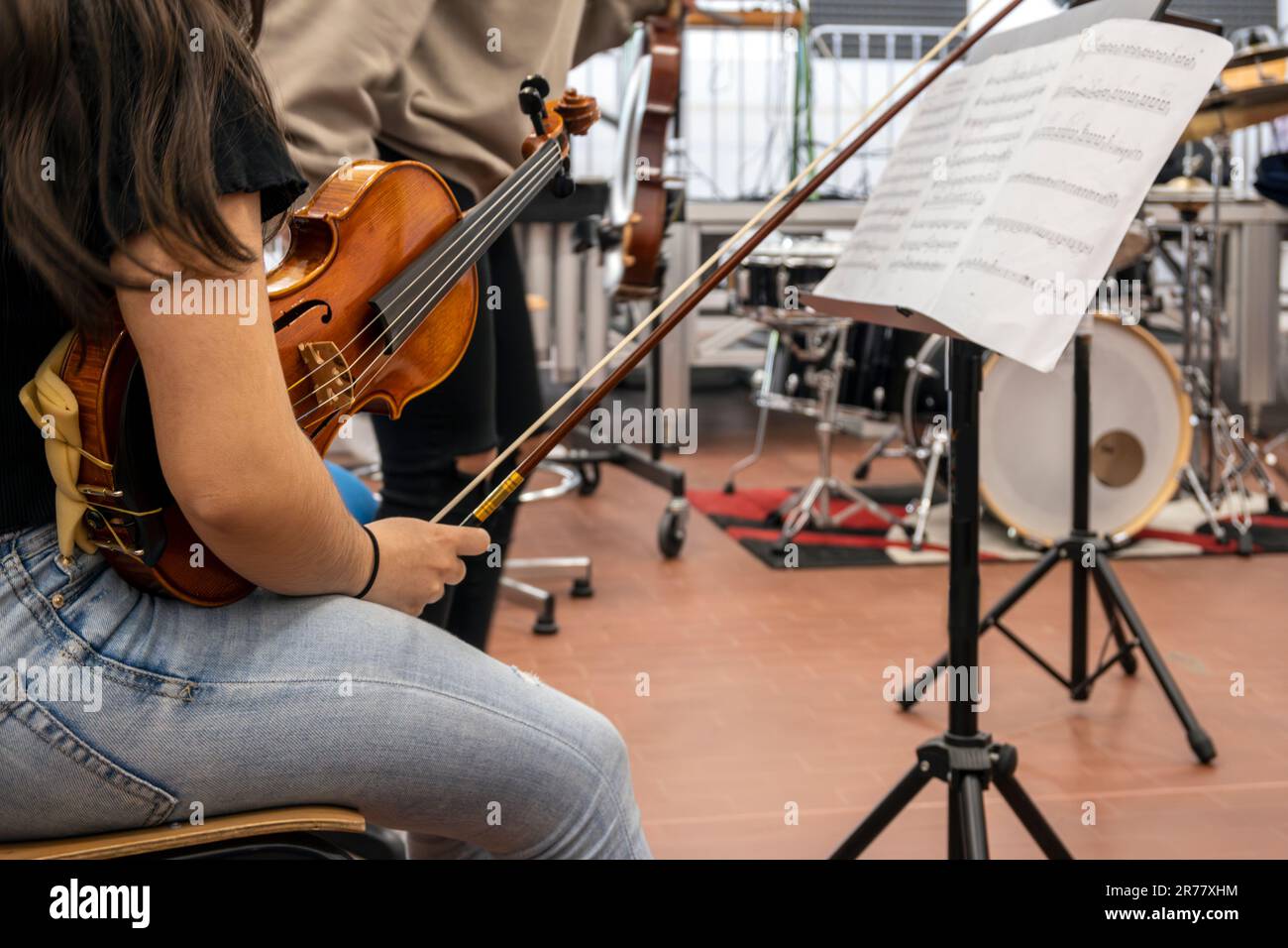 Real life young music students during rehearsals. Musical instruments