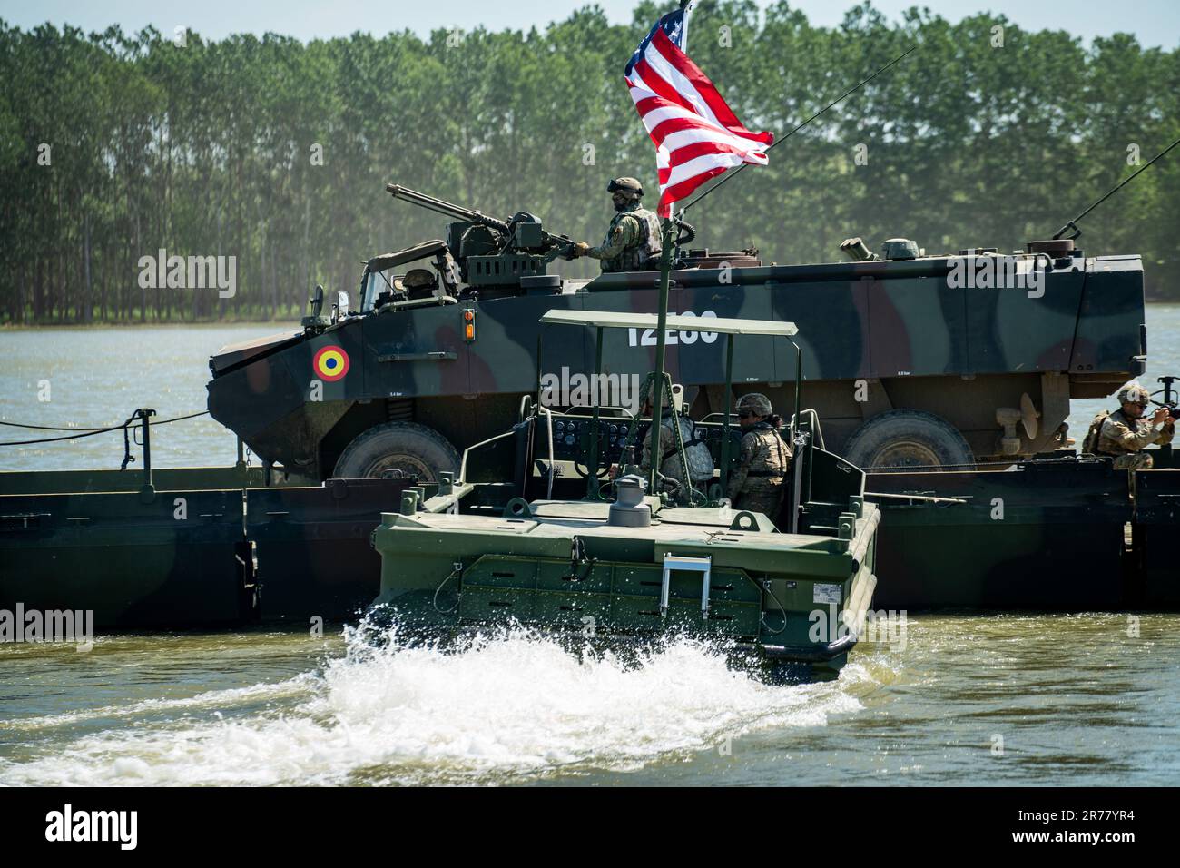 June 6, 2023 - Romania - U.S. Army boats assigned to the 50th Multi-role Bridge Company, 5th Engineer Battalion, ferry a Romanian Piranha III Armored Personnel Carrier across the Danube River near Bordusani, Romania, during the wet gap crossing exercise of Saber Guardian 23, June 6, 2023. The exercise is a component of DEFENDER 23, co-led by Romanian Land Forces and the U.S. Army at various locations in Romania to improve the integration of multinational combat forces by engaging in events such as vehicle road marches, medical training exercises and river crossings. (Credit Image: © U.S. Army/ Stock Photo