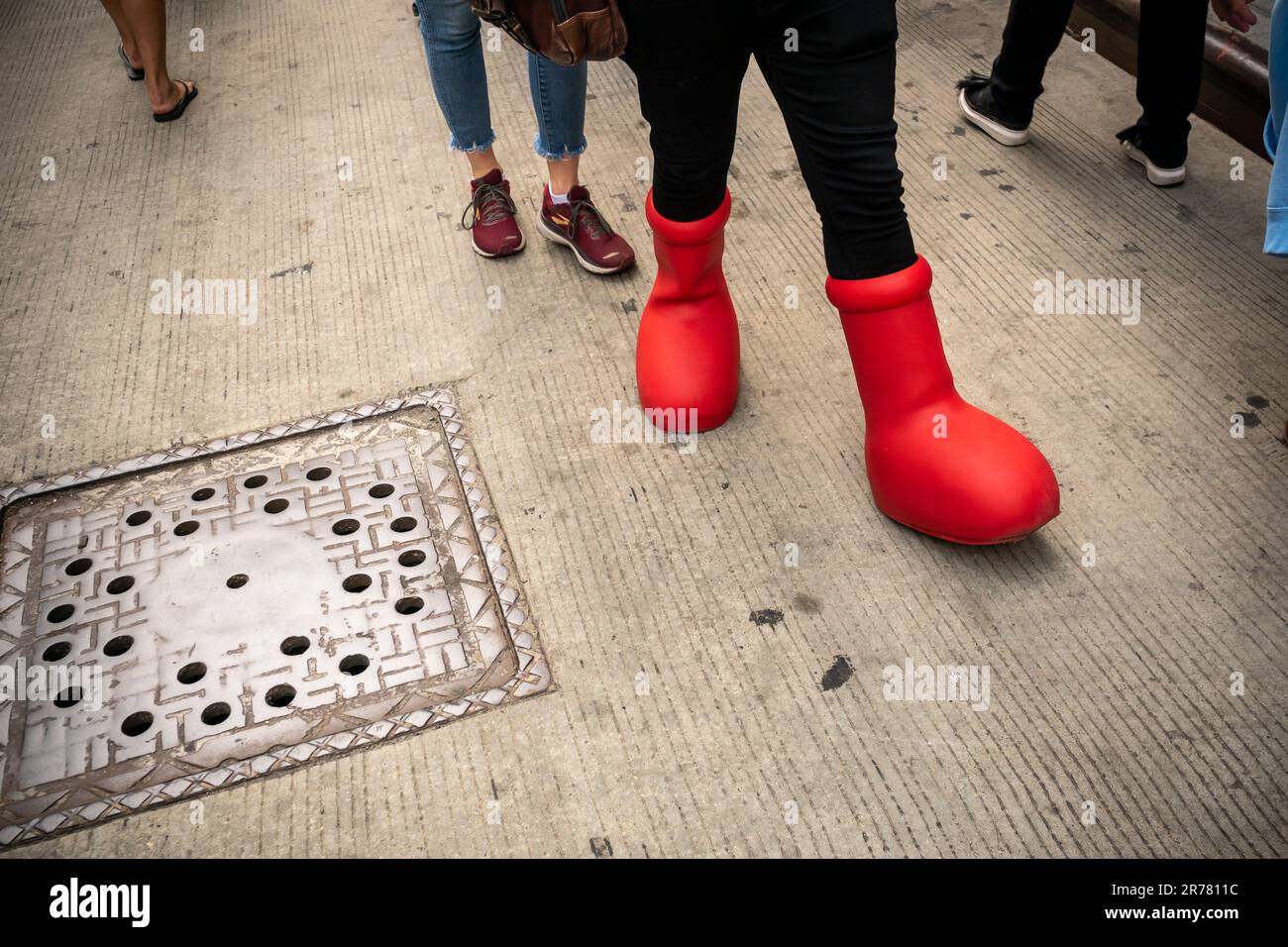 A Writers Guild of America East striker wears a pair of anime inspired boots created by MSCHF, a collective that parodies popular culture. The boots made their debut last February and have faded from social media and popular culture since then. (© Richard B. Levine) Stock Photo