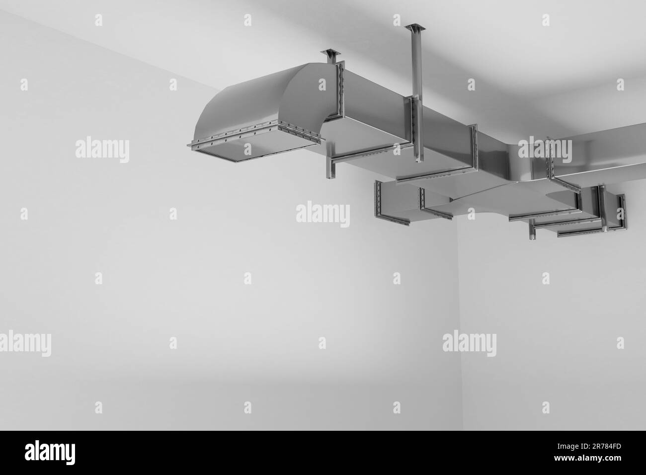 industrial air conditioning system HVAC pipes on ceiling in empty room. 3d render illustration Stock Photo