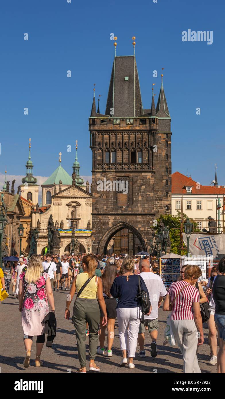 PRAGUE, CZECH REPUBLIC - Tourists crossing Charles Bridge. Old Town Bridge Tower at rear. Stock Photo