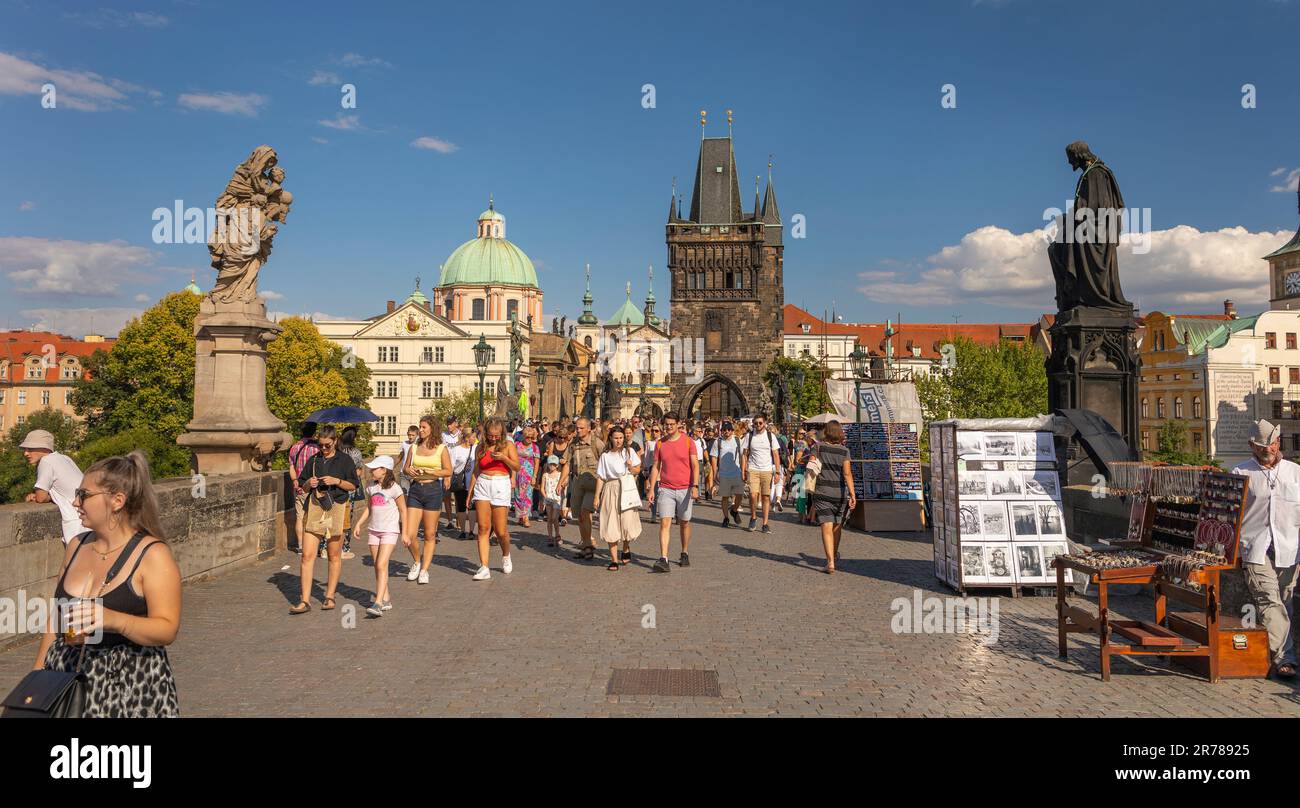 PRAGUE, CZECH REPUBLIC - Tourists crossing Charles Bridge. Old Town Bridge Tower at rear. Stock Photo