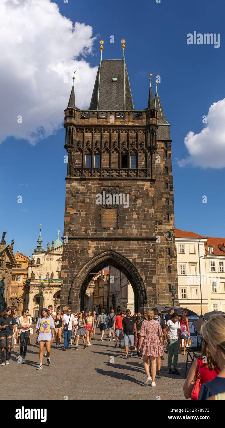 PRAGUE, CZECH REPUBLIC, EUROPE - The Old Town Bridge Tower, and tourists crossing Charles Bridge. Stock Photo