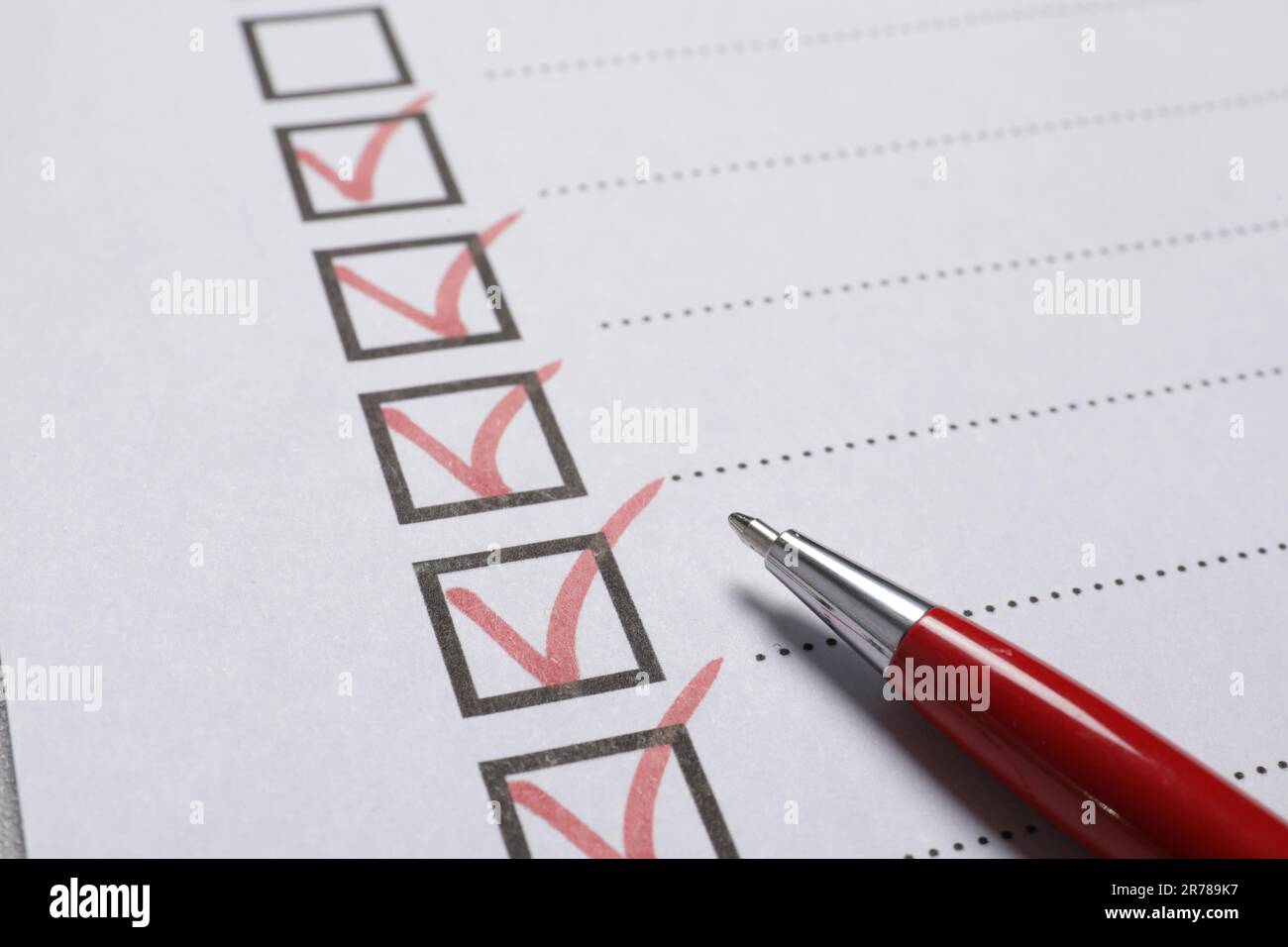 Pen on paper sheet with checkboxes, closeup. Checklist Stock Photo - Alamy