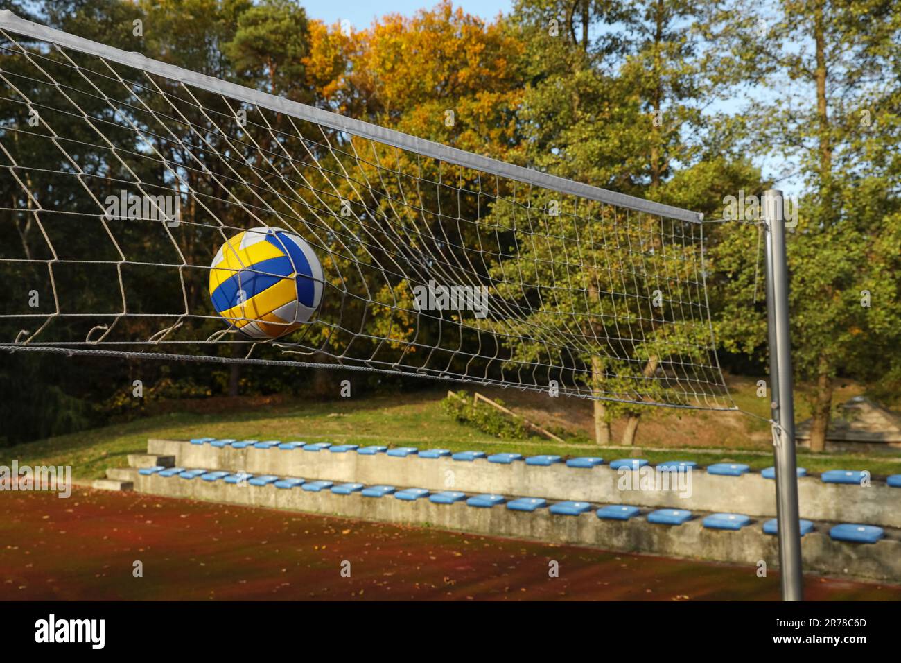 Ball hitting into volleyball net on court outdoors Stock Photo Alamy