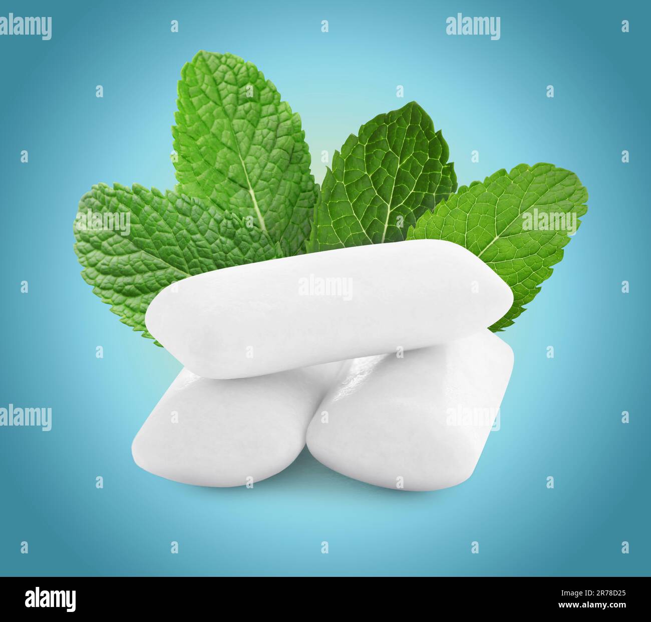 Menthol chewing gum pillows and mint leaves on blue gradient background