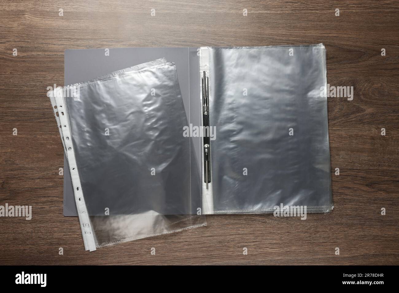 File folder with punched pockets on wooden table, flat lay Stock Photo