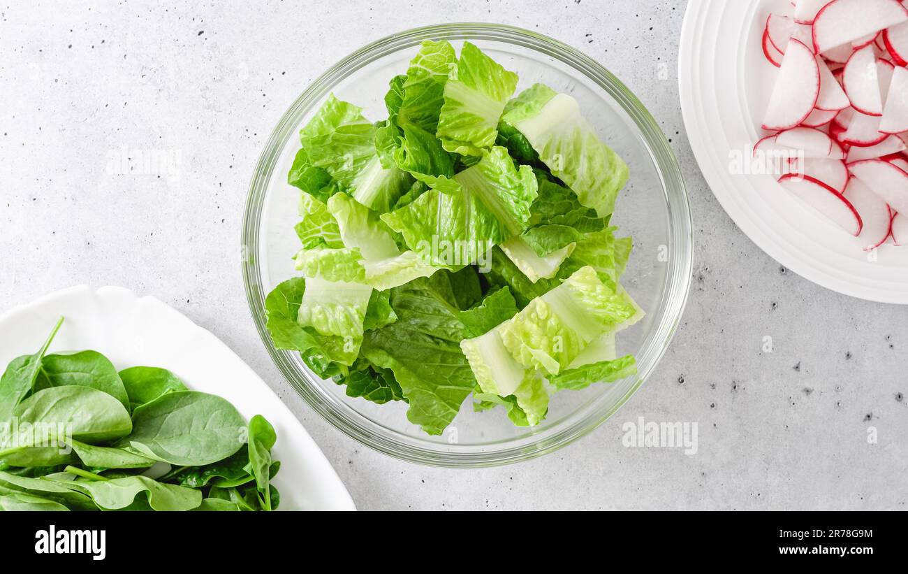 Spring mix salad in a glass bowl. Romaine lettuce, baby spinach, and