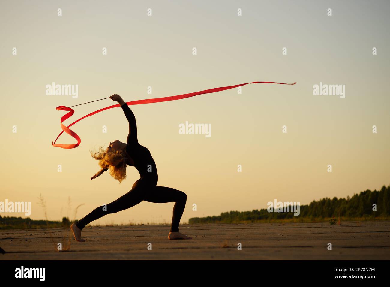 Professional gymnast woman dancer posing with ribbon Stock Photo - Alamy