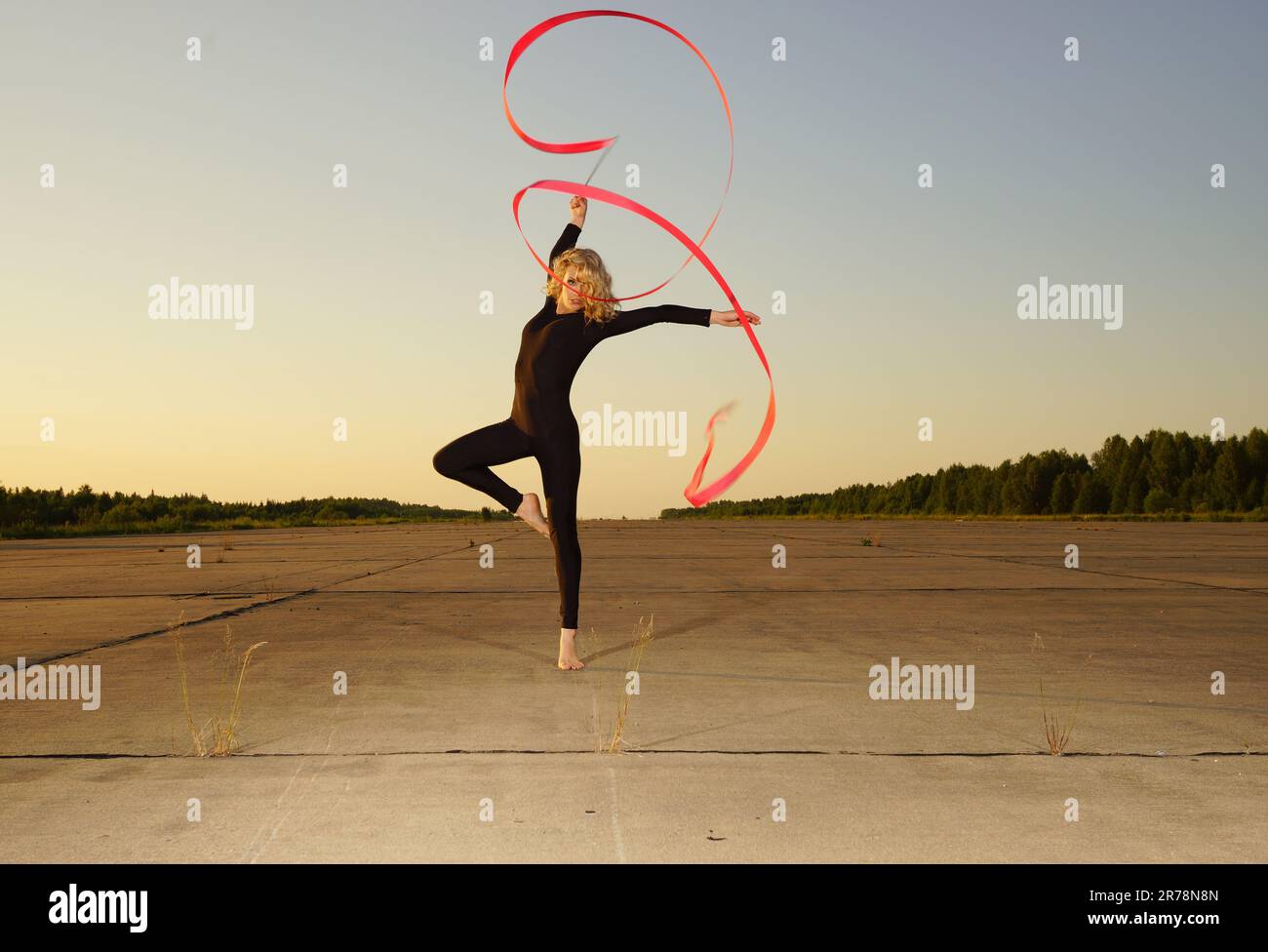 Professional gymnast woman dancer posing with ribbon Stock Photo - Alamy