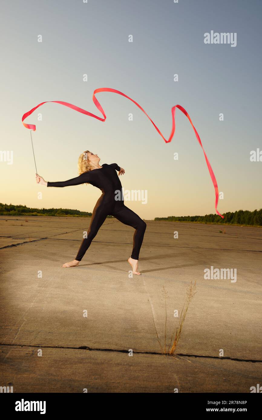 Professional gymnast woman dancer posing with ribbon Stock Photo - Alamy