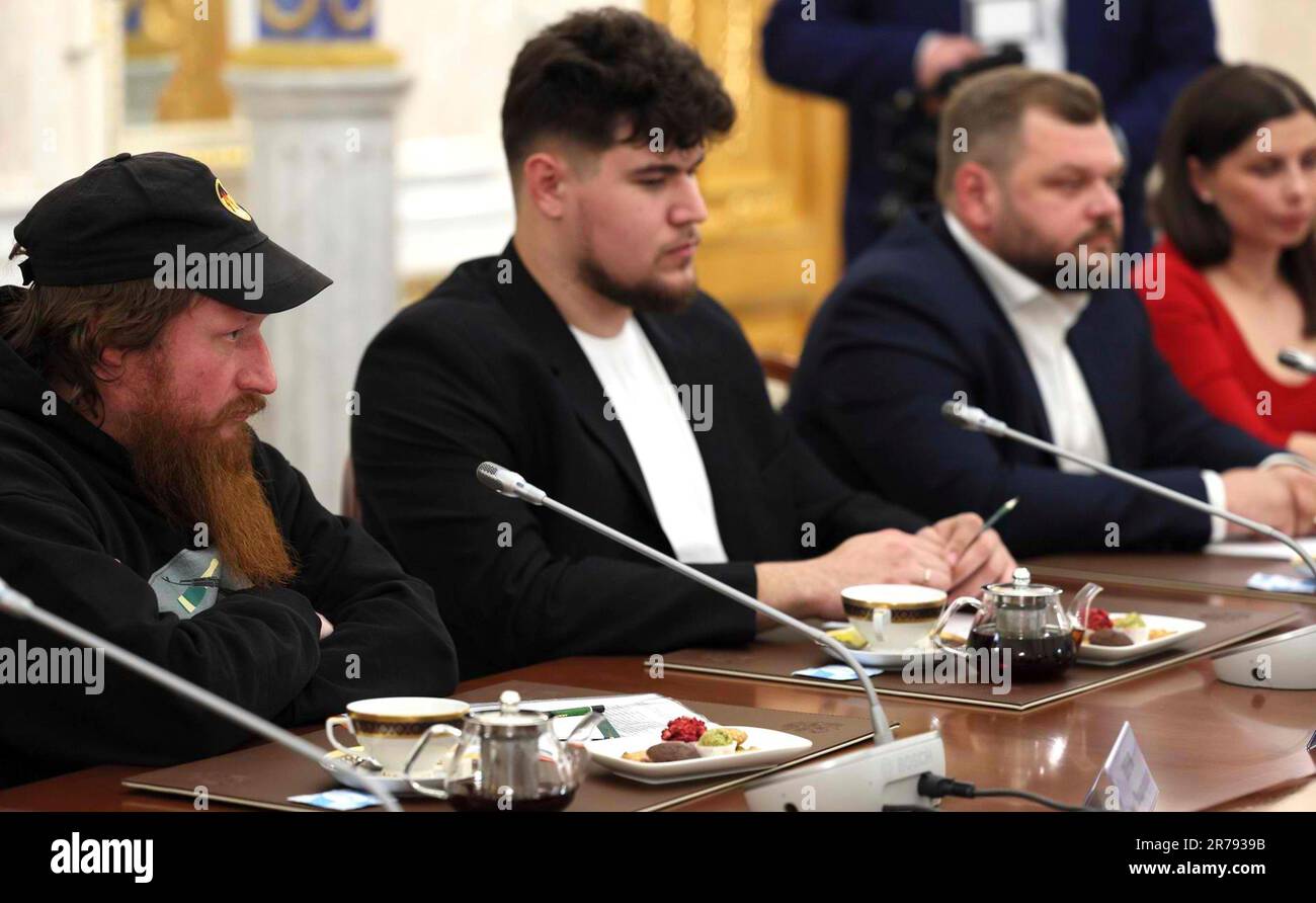 Moscow, Russia. 13th June, 2023. Right-wing pro-Kremlin blogger Semyon Pegov, left, with the WarGonzo project listens to President Vladimir Putin during a face-to-face meeting with Russian war correspondents and pro-Kremlin bloggers at the Grand Kremlin Palace, June 13, 2023 in Moscow, Russia. Credit: Mikhail Klimentyev/Kremlin Pool/Alamy Live News Stock Photo