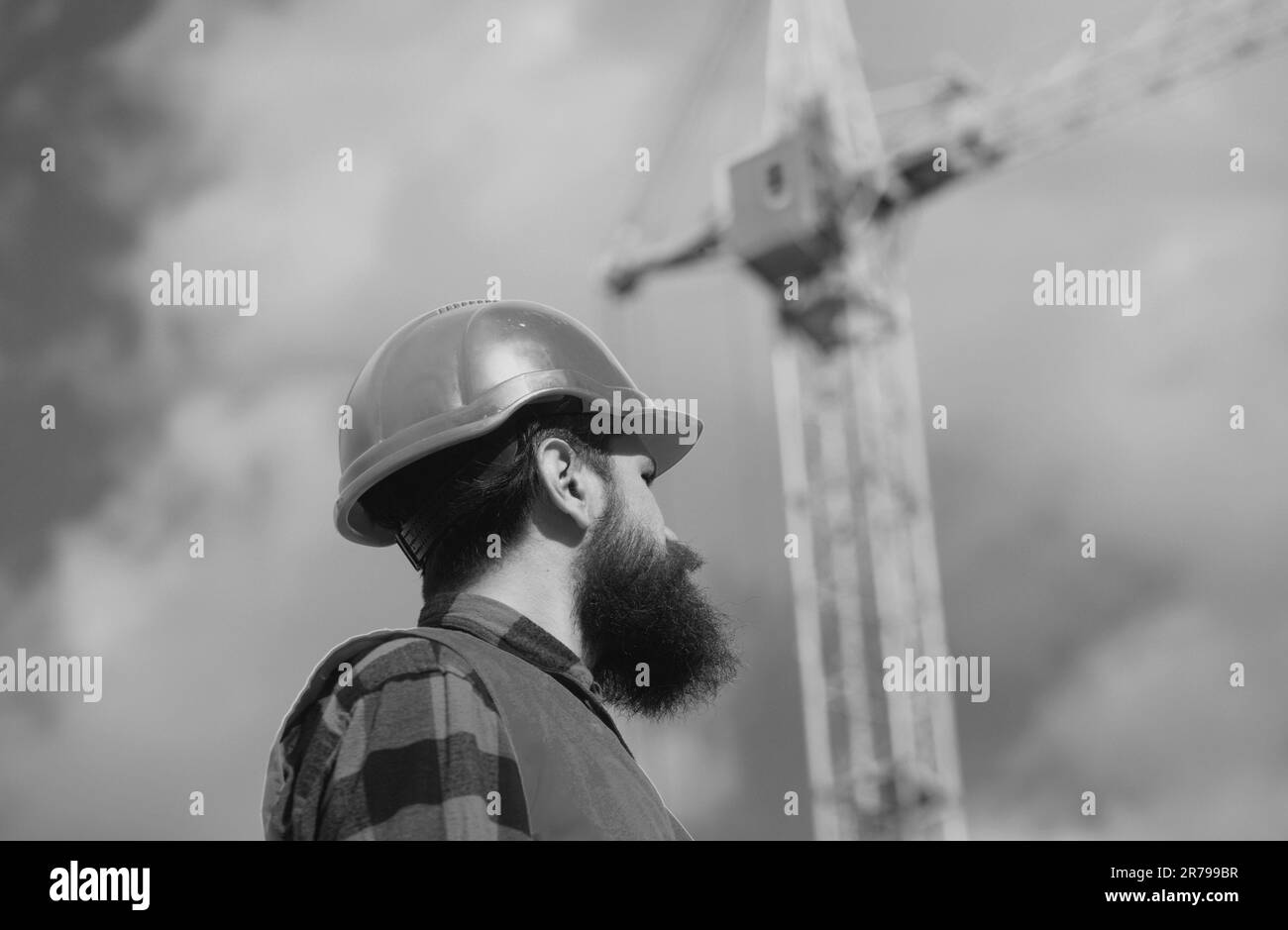 Male construction worker in work clothes and a construction helmet