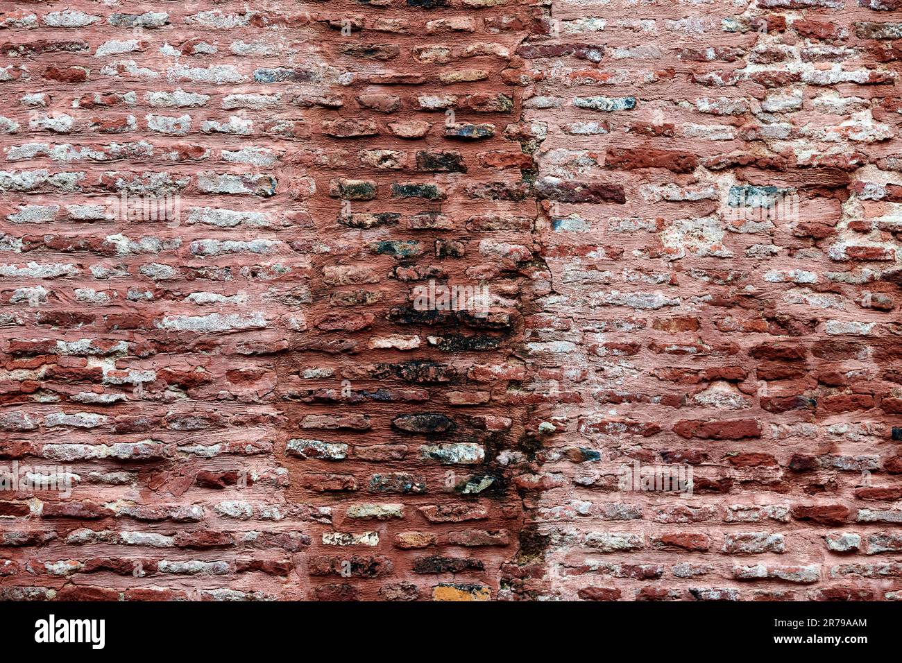 Ancient red brick wall of old house exterior, red brick texture on brickwork masonry with