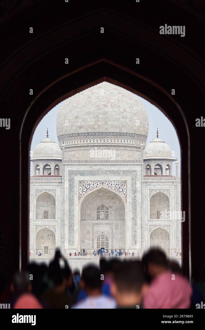 Archway of main gateway in Taj Mahal entrance with tourists silhouettes ...