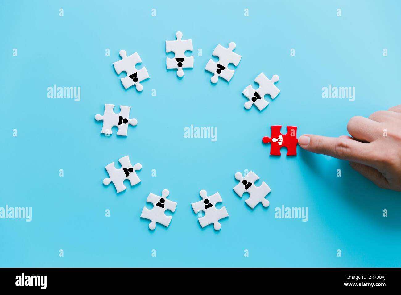 Human resources management and recruitment business build team concept. Image of tangram puzzle blocks with people icons over wooden table ,human reso Stock Photo