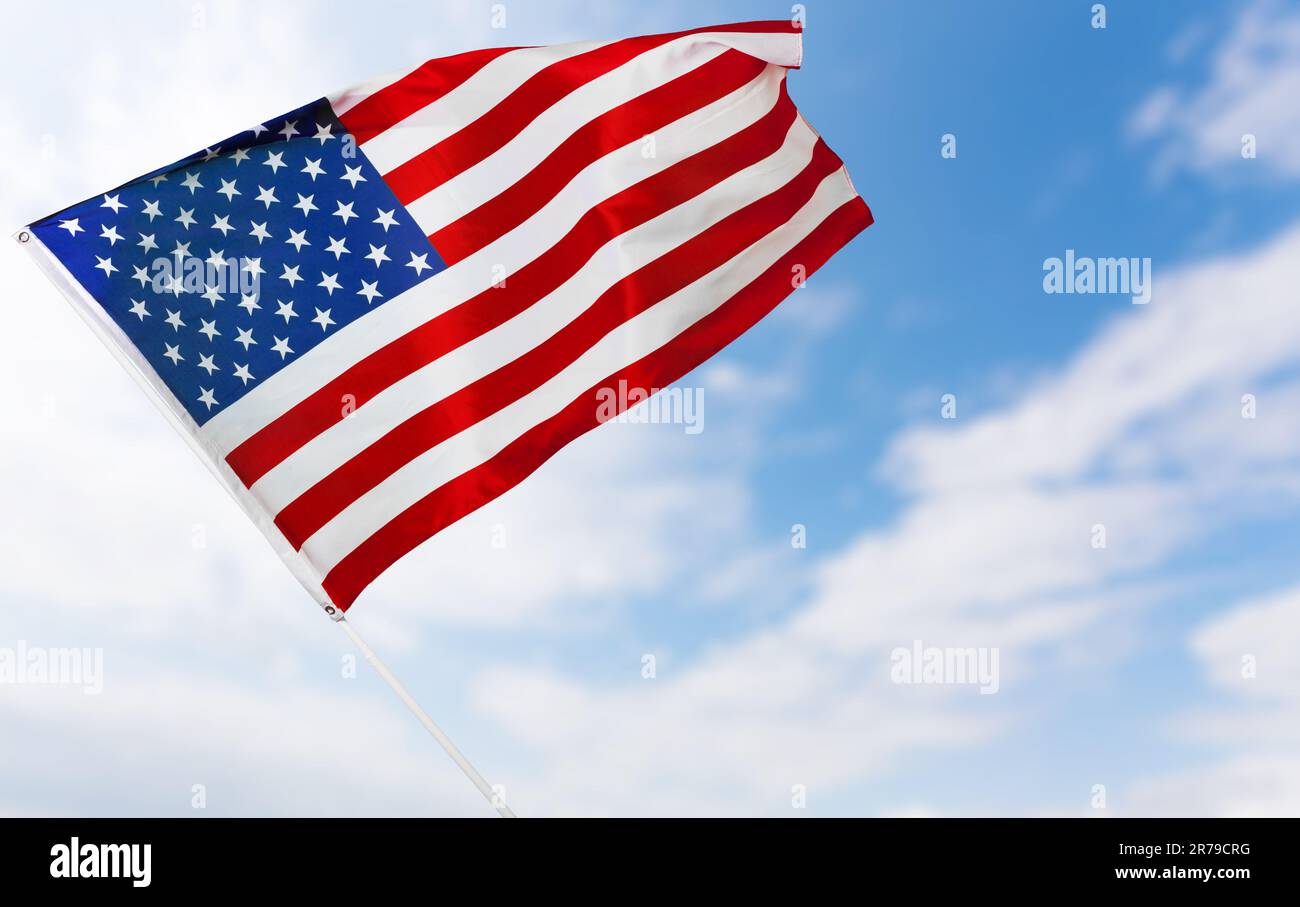 American flag against blue sky Stock Photo - Alamy