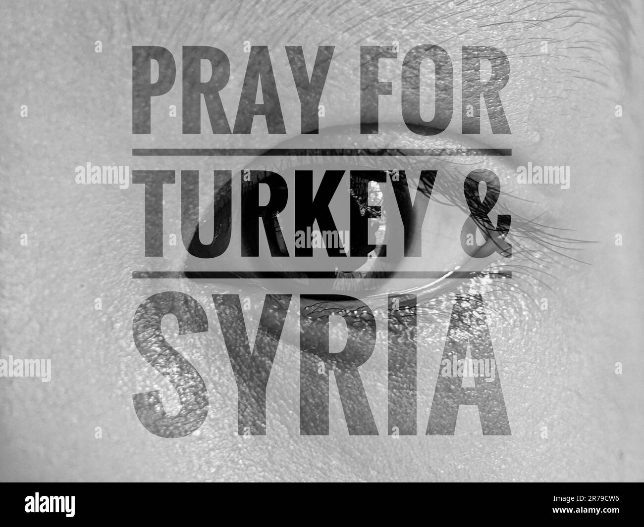 A person eye with the words 'Pray for Turkey' overlaid in text Stock Photo