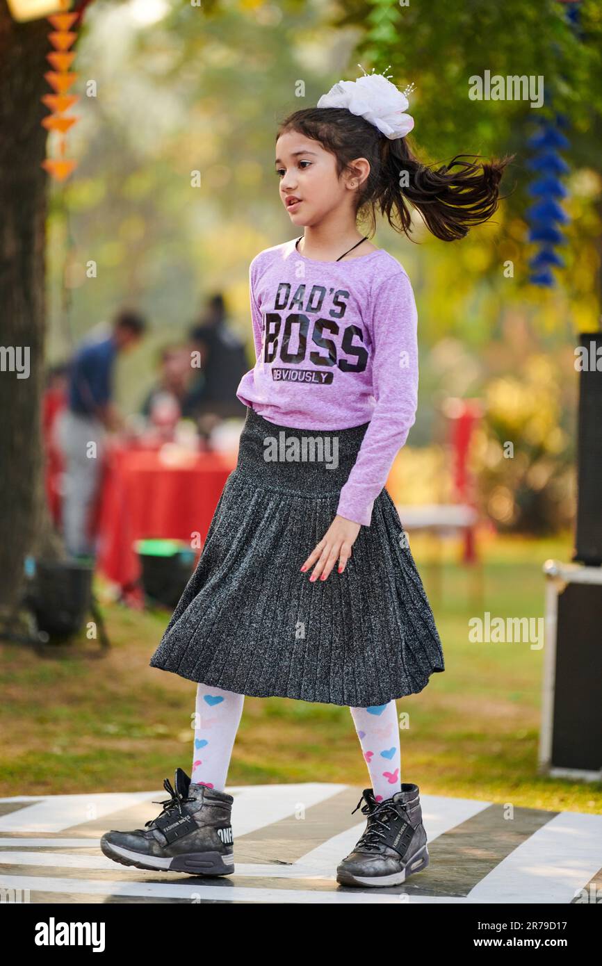 New Delhi, India 10.12.2022 Little girl dance to music at outdoor