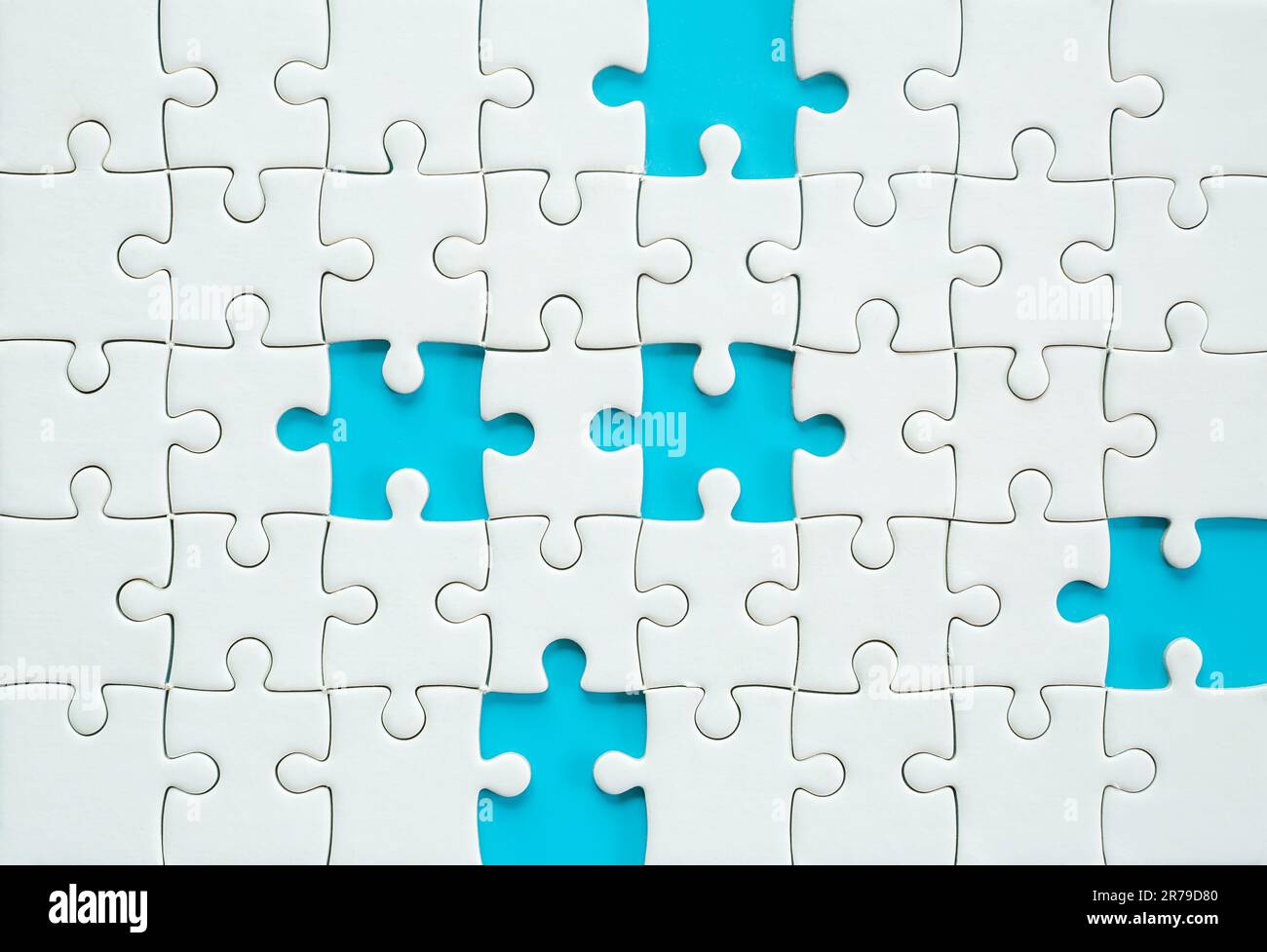 White part of jigsaw puzzle pieces on blue background. concepts of problem solving, business success, teamwork, Team playing jigsaw game incomplete, T Stock Photo
