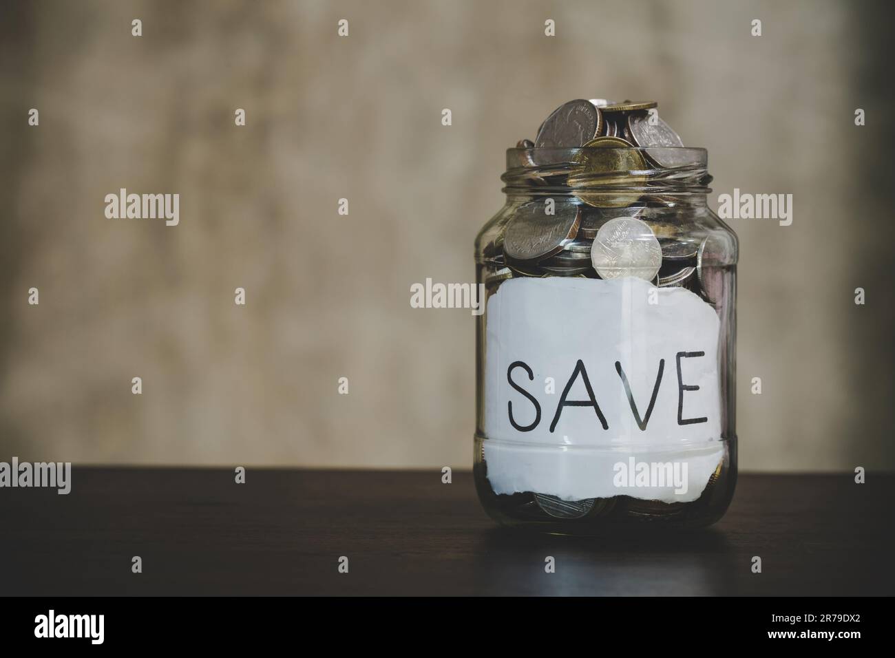 Savings deposit coins in a clear glass bottle Stock Photo Alamy