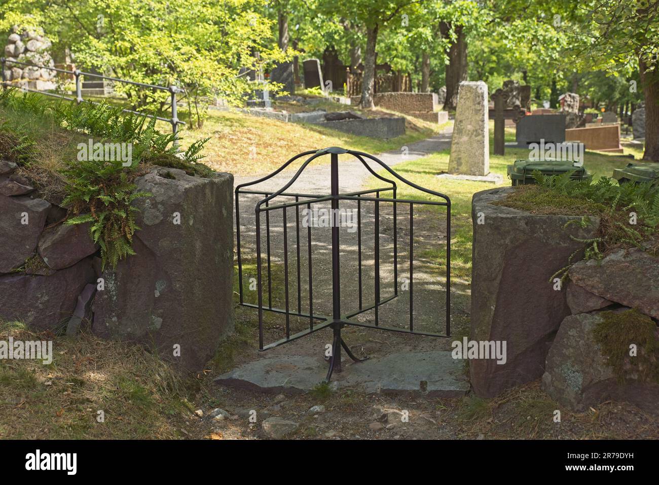 Revolving iron cemetery gate in summer, Tammisaari, Finland. Stock Photo