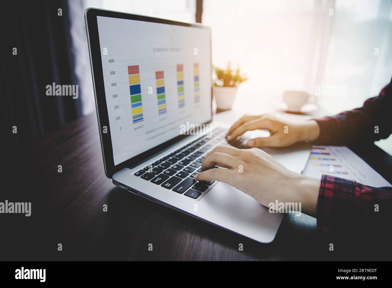 Businesswoman looking at charts, spreadsheets, graph financial