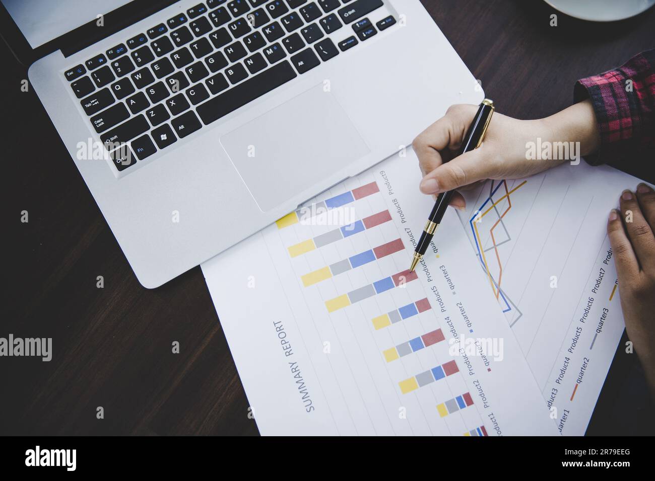 Businesswoman looking at charts, spreadsheets, graph financial