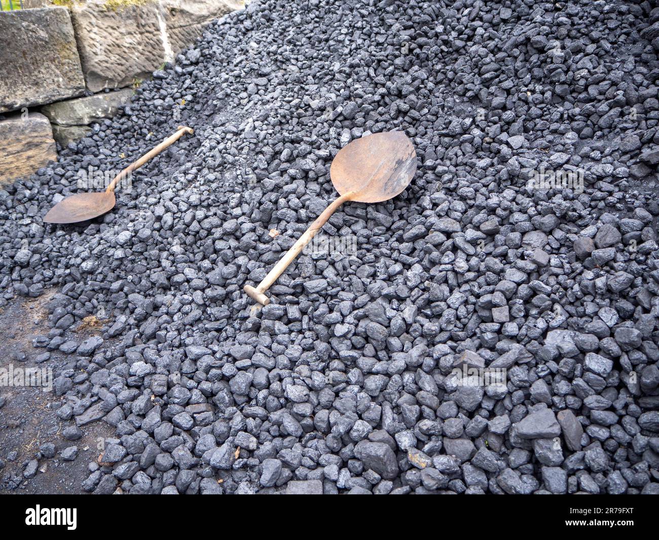 Coal pile at the steam train station with a pair of abandoned shovels waiting to be used at Beamish Museum, County Durham, UK Stock Photo