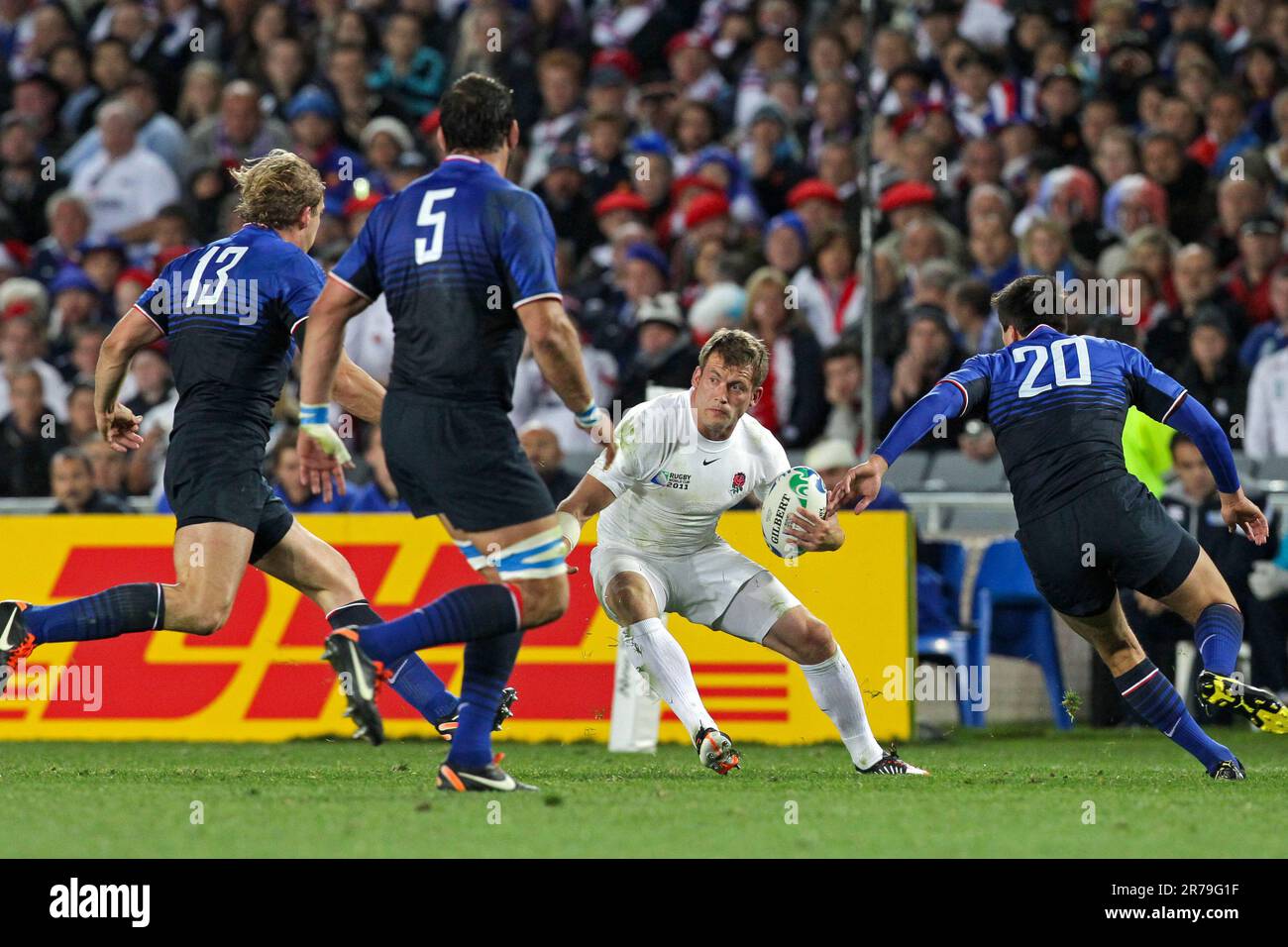 England's Mark Cueto is challenged by France’s Aurélien Rougerie, left, Lionel Nallet and Francois Trinh-Duc during quarter-final 2 match of the Rugby World Cup 2011, Eden Park, Auckland, New Zealand, Saturday, October 08, 2011. Stock Photo