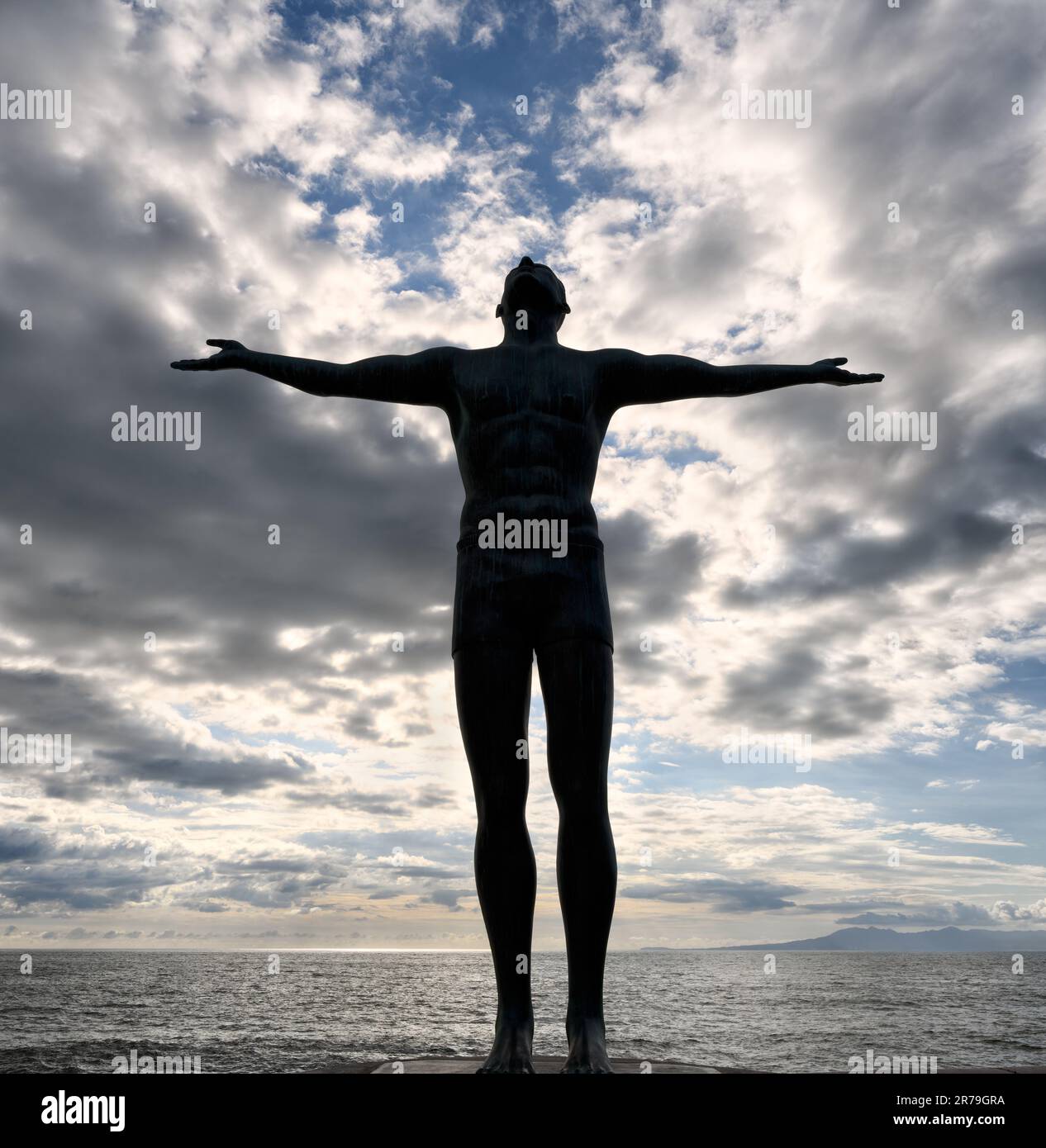 A Silhouette Of A Man With Outstretched Arms Looking Up To The Sky Vertical Stock Photo