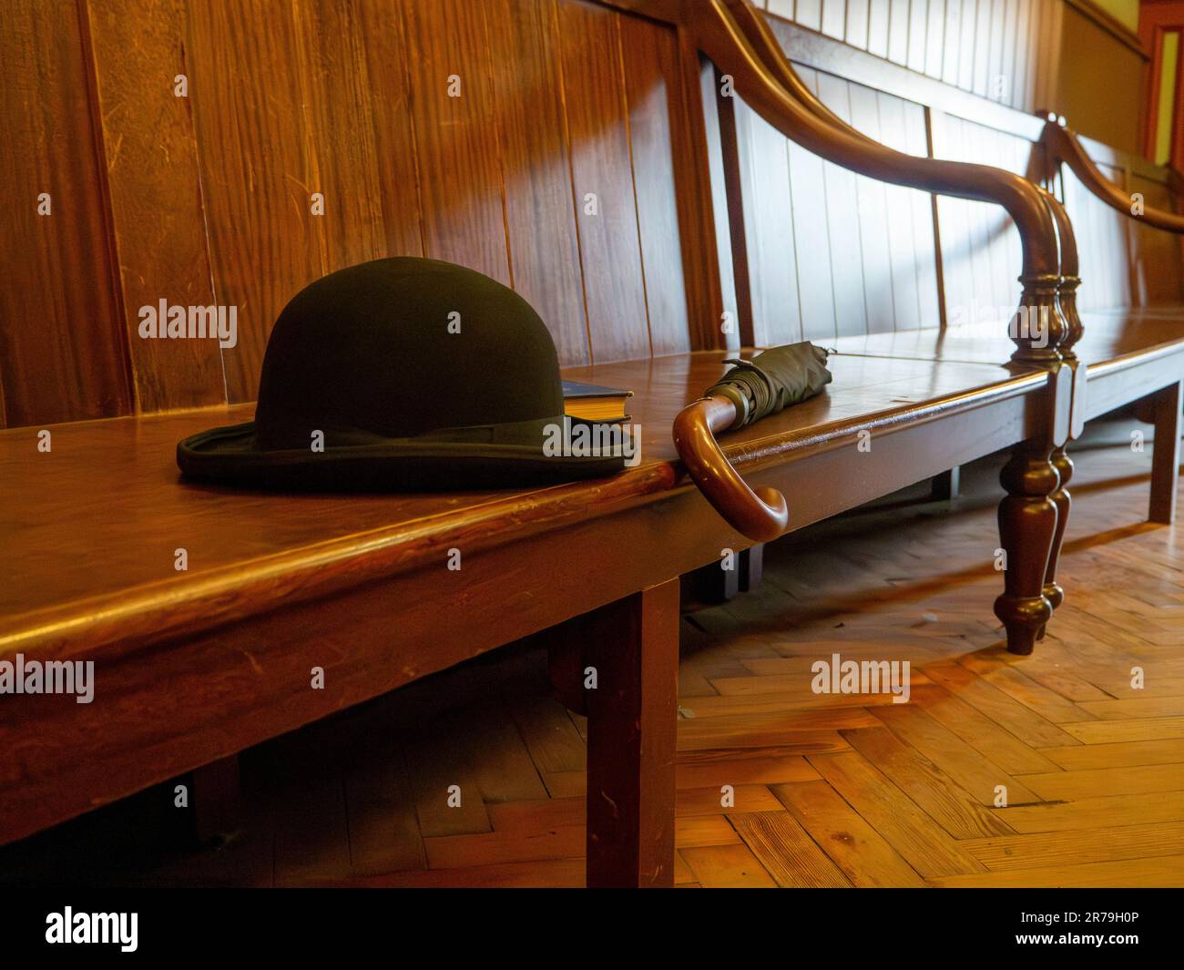 Bowler hat left with a matching umbrella in the Masonic Hall in the 1900s town at Beamish Museum, Stanley, County Durham, UK Stock Photo