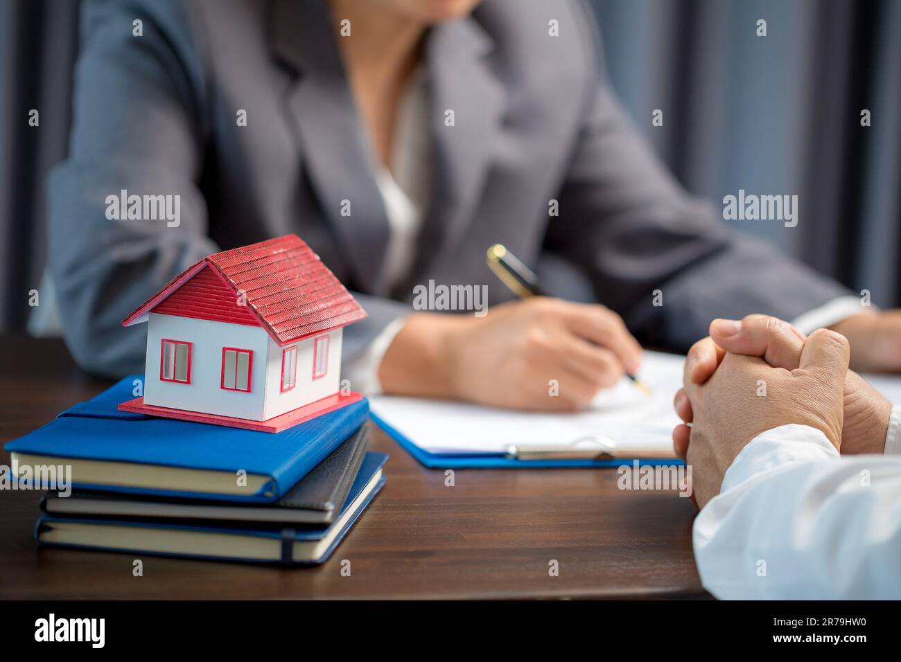 Woman home sales person is checking documents for house purchase