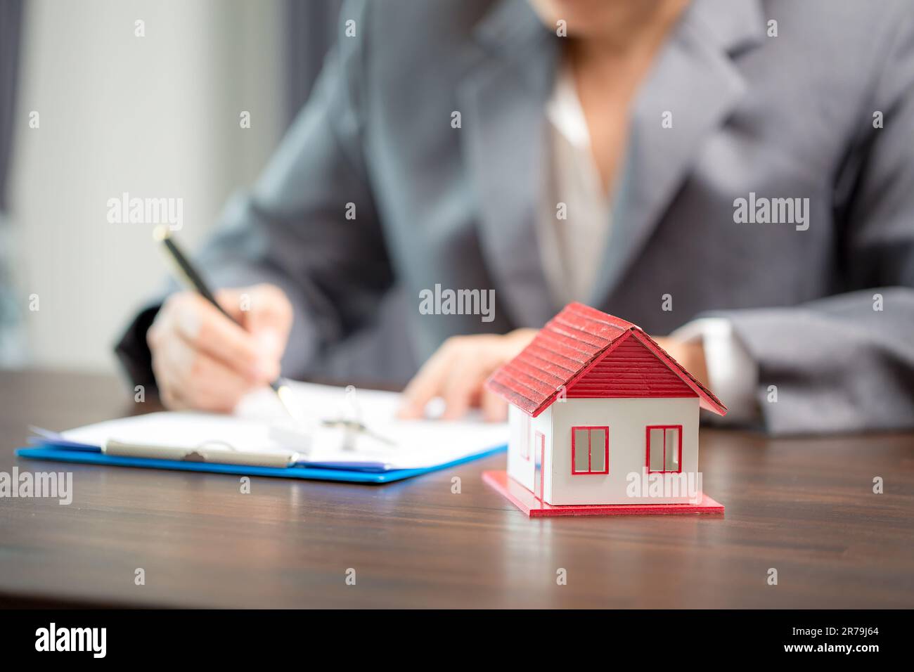 Woman home sales person is checking documents for house purchase