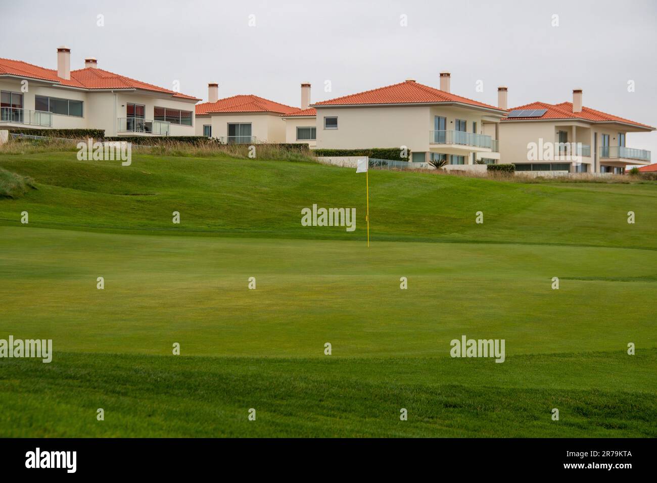 Green golf course perfectly cut, in a housing complex by the sea Stock Photo