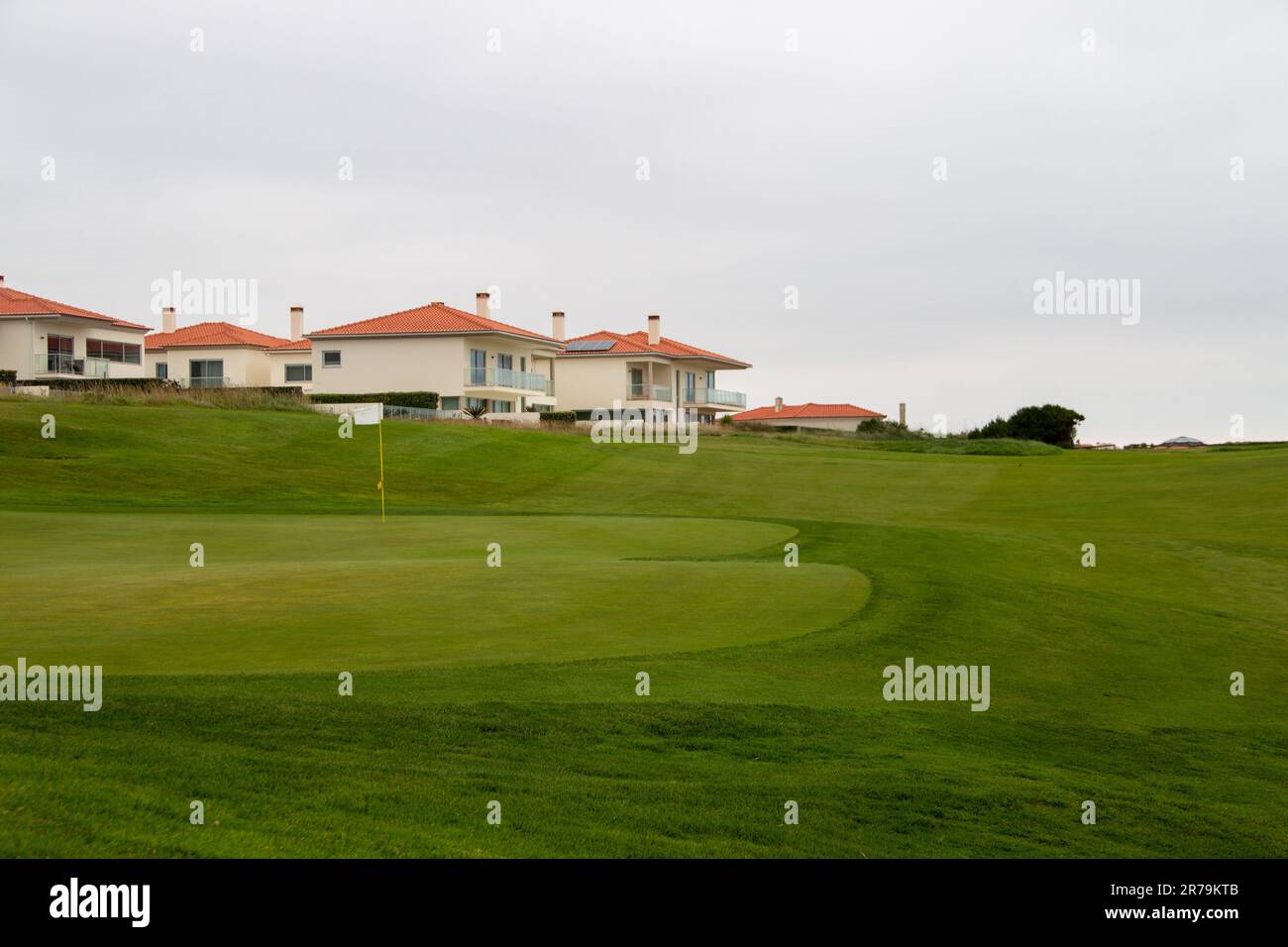 Green golf course perfectly cut, in a housing complex by the sea Stock Photo