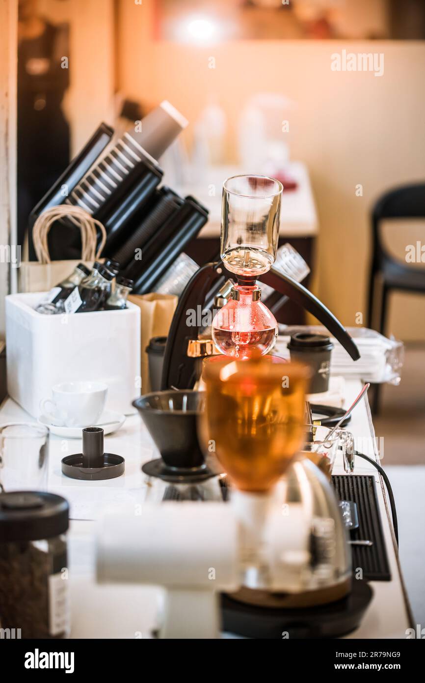Professional coffee maker Barista using coffee siphon brewing hot